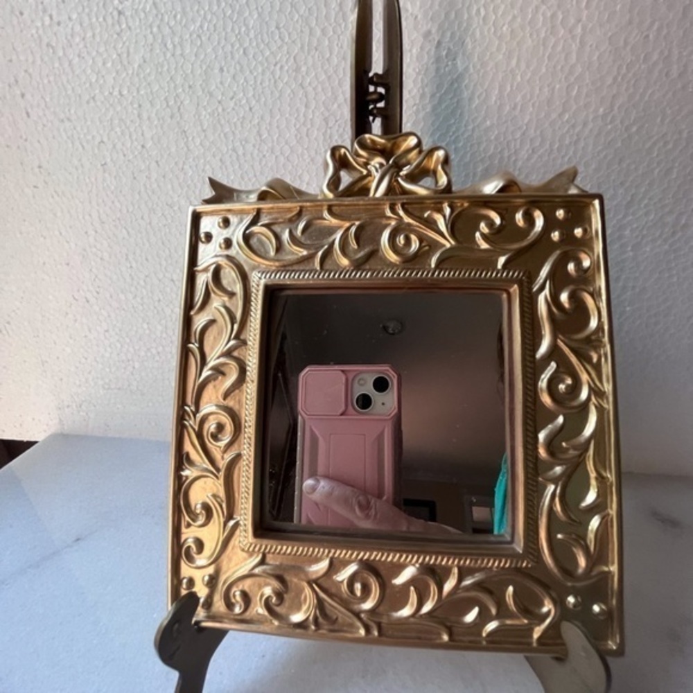 Vintage ornate gold wall mirror, accent mirror. Bow decorated frame